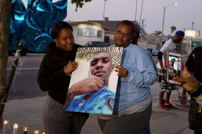 Danita Lashay and Beverly Owens Addison hold a photo of Woon. Sahra Sulaiman/Streetsblog L.A.