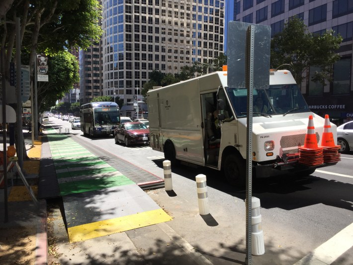 DWP vehicle and car blocking DASH bus in the bus-only lane. The sign facing away is the no right turn sign shown above.