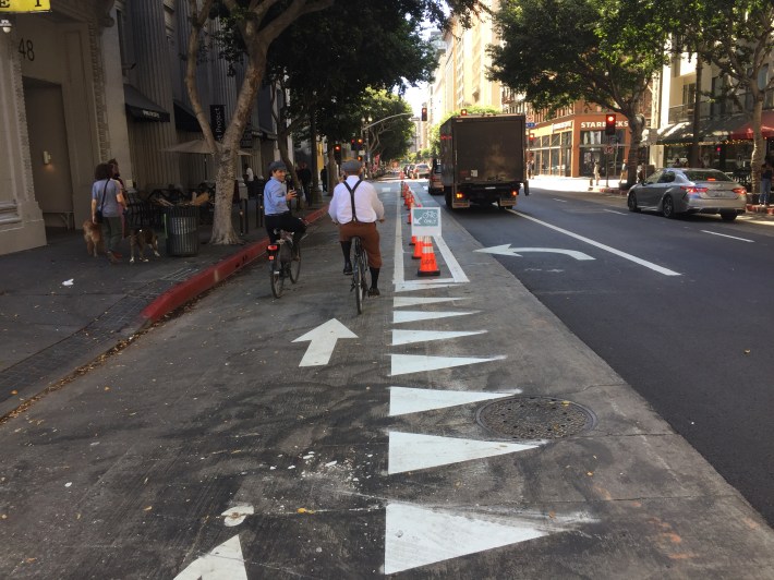 Spring Street's parking-protected bike lane is wide enough for two cyclists to ride side-by-side