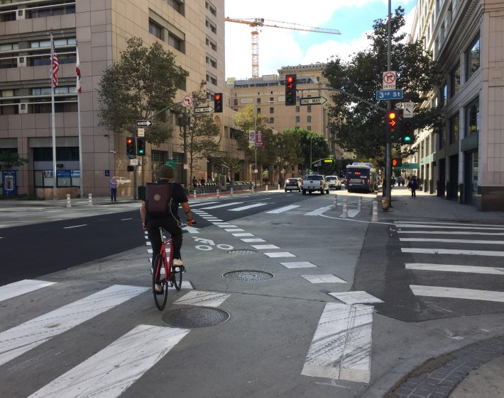 Cyclists have their own bike signal and pavement marking, allowing them to cross to the left at 3rd Street