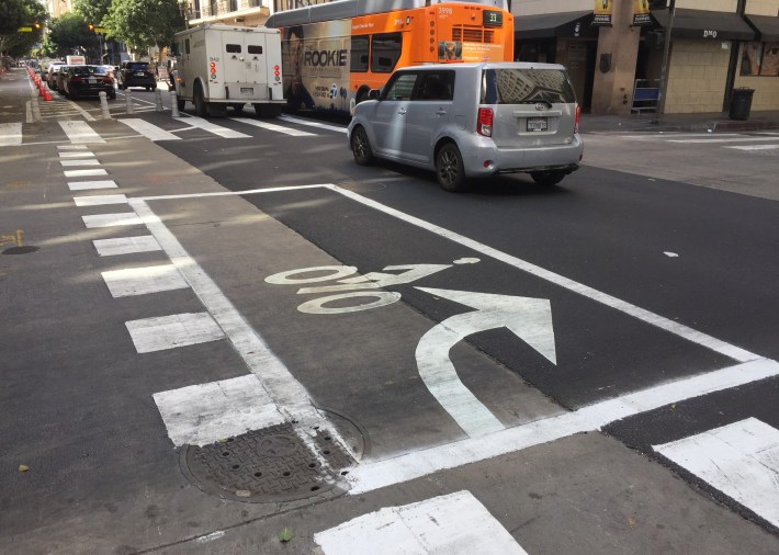 At streets with right-turning traffic (5th Street pictured) cyclists can turn via a bike box painted in the intersection