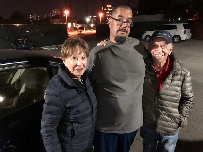 Andre Sanchez during his last night in a Safe Parking Lot before heading to a house in Arizona(middle) with Safe Parking LA founders Ira Cohen and Pat Cohen. Photo: Damien Newton