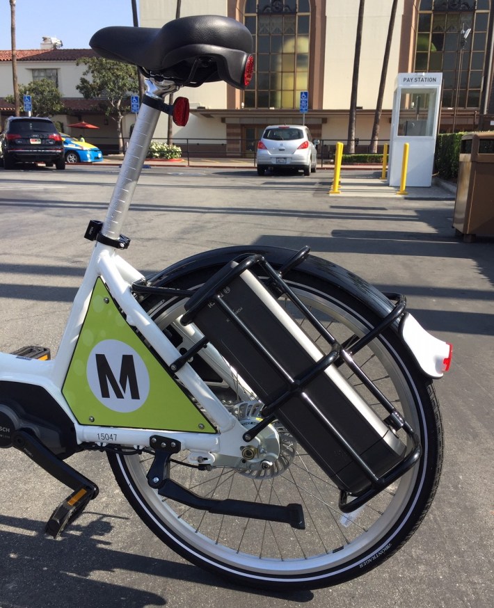 Metro's e-bikes are white, with a battery located along the back wheel