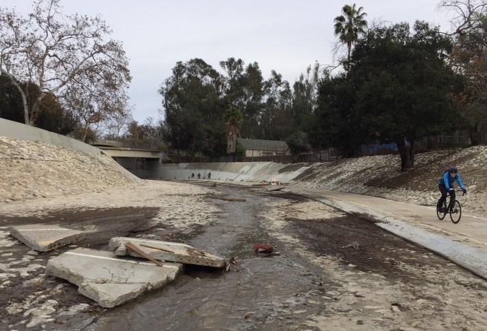 Dislodged chunks of concrete bike path in the bed of the Arroyo Seco