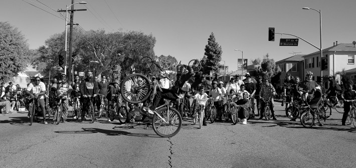 BKoB started the parade with 15 or 20 riders but accumulated another 40 or 50 as they moved along the route. Here the group pauses just short of Crenshaw Boulevard. Sahra Sulaiman/Streetsblog L.A.