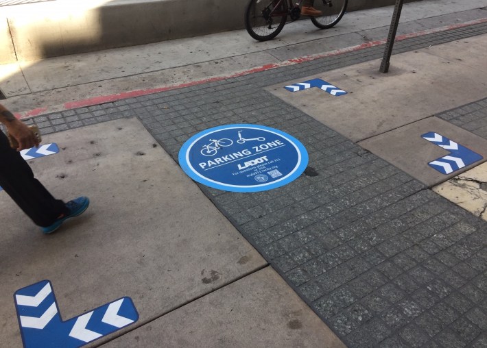 Shared device parking spot on the Figueroa Street sidewalk in downtown L.A.