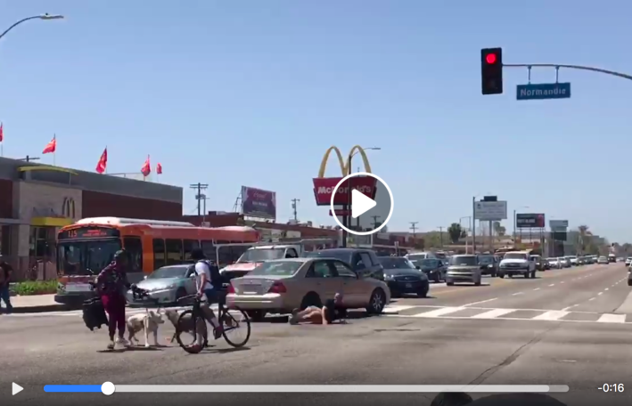 Quatrell Stallings lies on the ground after deliberately being hit by 19-year-old Alana Ealy. [Screenshot KTLA Facebook stream]