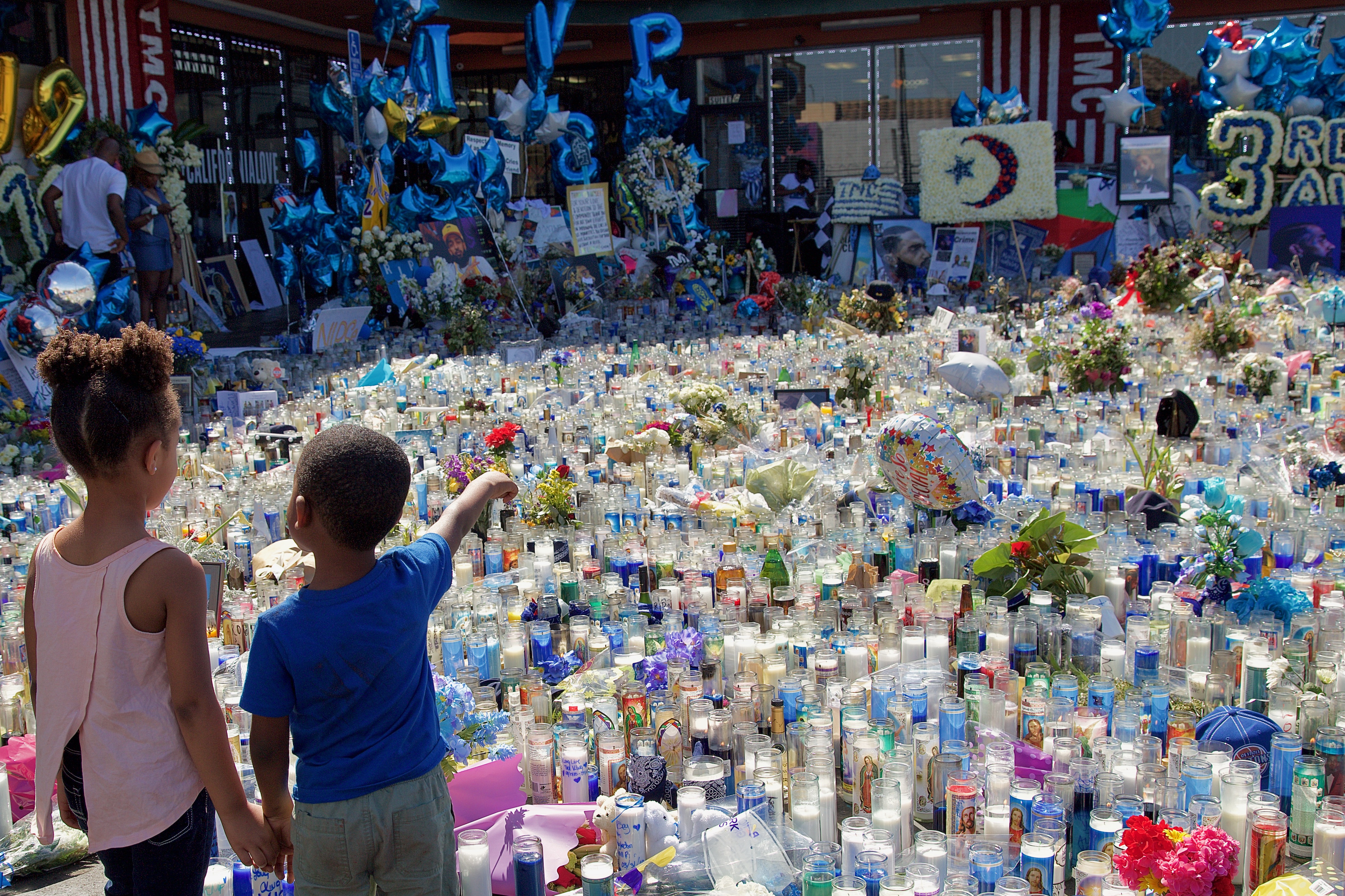 The memorial to Nipsey Hussle sits in front of The Marathon store in the strip mall where he spent much of his life and where he worked to uplift the community. He died here March 31. Sahra Sulaiman/Streetsblog L.A.