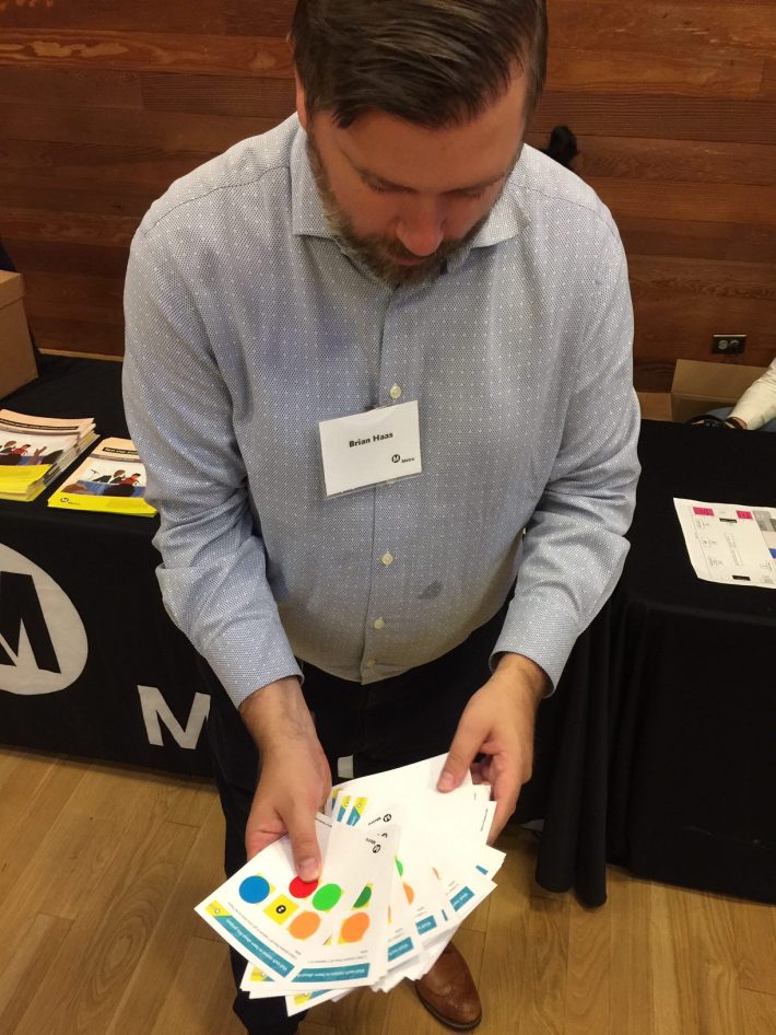 Metro's Brian Haas shows off stickered participation cards
