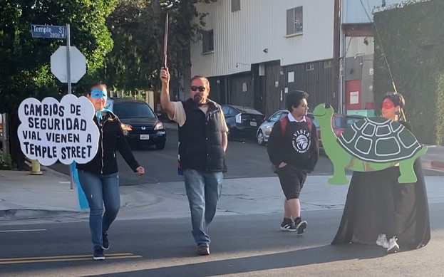 Superheroes walking safely across Temple Street - photo via L.A. Walks