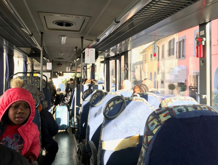 Full-size bus on small street between Lucca and Pisa