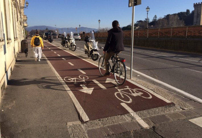 Protected two-way bikeway near the Arno River in Florence