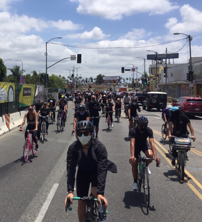 Ride for Justice cyclists passing the future Leimert Park Crenshaw light rail station under construction