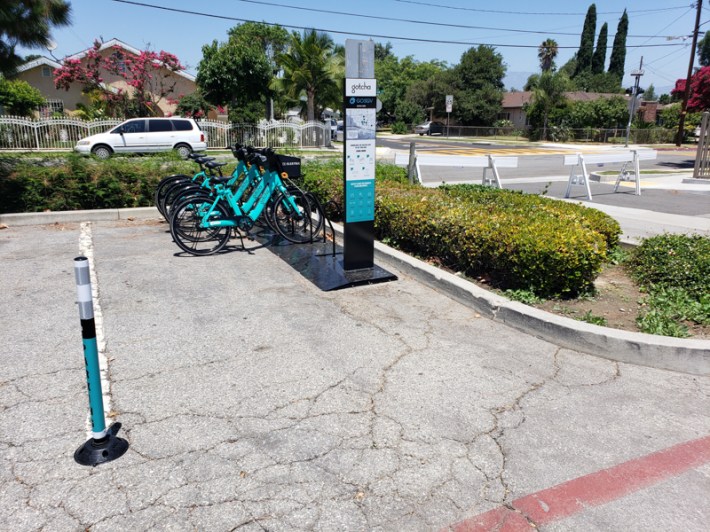 GoSGV e-bikes parked in a former general parking stall in front of Shiveley Park in South El Monte. Kristopher Fortin/Streetsblog LA