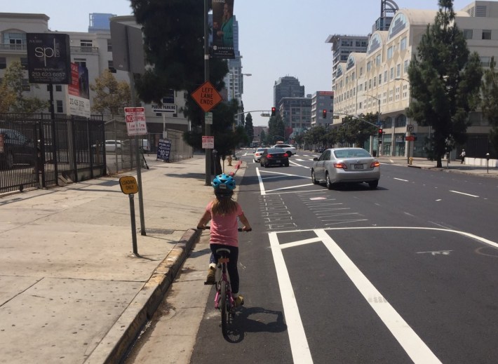 New parking-protected bike lane on Grand Avenue is nearly complete. Photos by Joe Linton/Streetsblog L.A. (My daughter appears in the photos.)