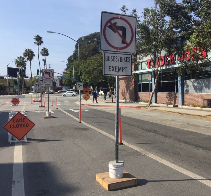 Temporary no left turn signage has been beefed up preventing drivers from turning into the bus/bike lane in downtown Culver City. Compare to earlier photo.