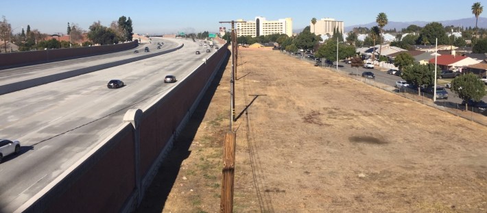 This vacant land, viewed from Norwalk's Silverbow Avenue pedestrian overpass, was more than a dozen homes. Metro and Caltrans have demolished hundreds of homes for their South 5 Freeway widening project. Photos by Joe Linton/Streetsblog L.A.