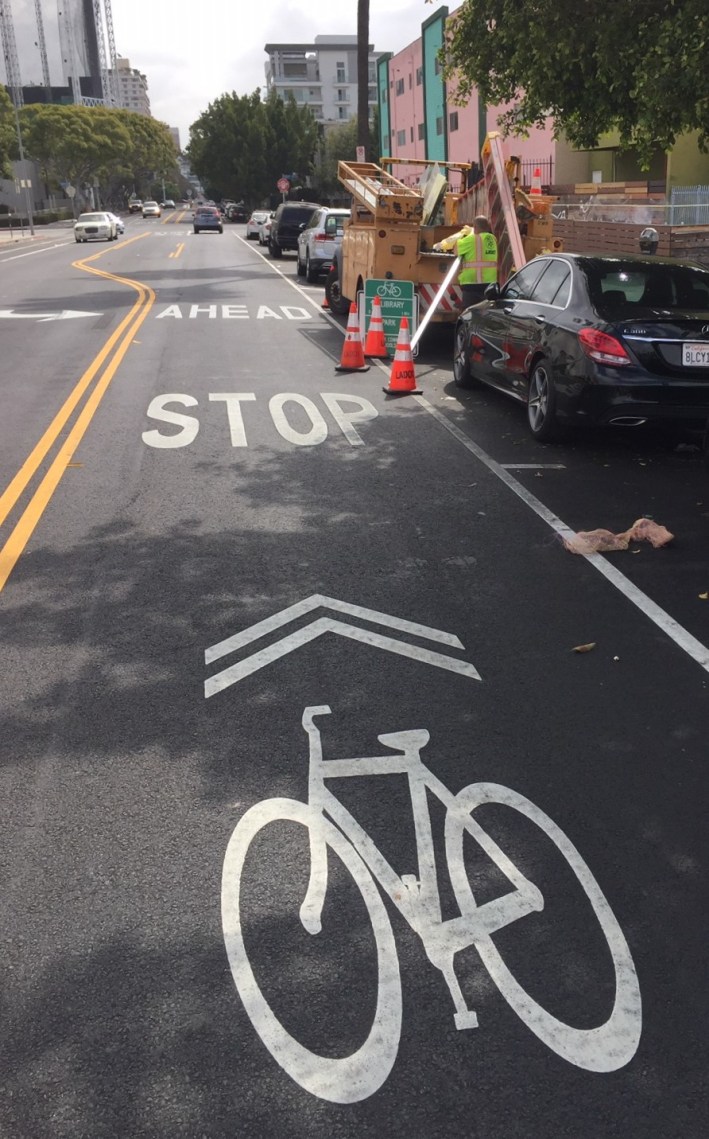 For one block - between Western and xxx, there is a westbound bike lane and eastbound sharrows. Note also the LADOT crew working on installing bikeway signage earlier today.