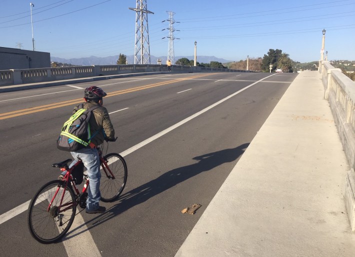 The eastbound bike lanes could have been added in 2018 when bridge construction was completed. Cyclists used the diagonally-striped-off area.