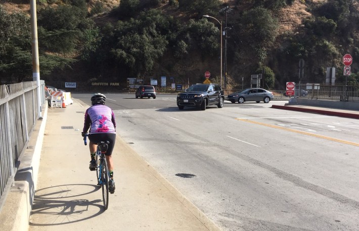 Cyclists already freeway on-/off-ramps by riding south on the east sidewalk