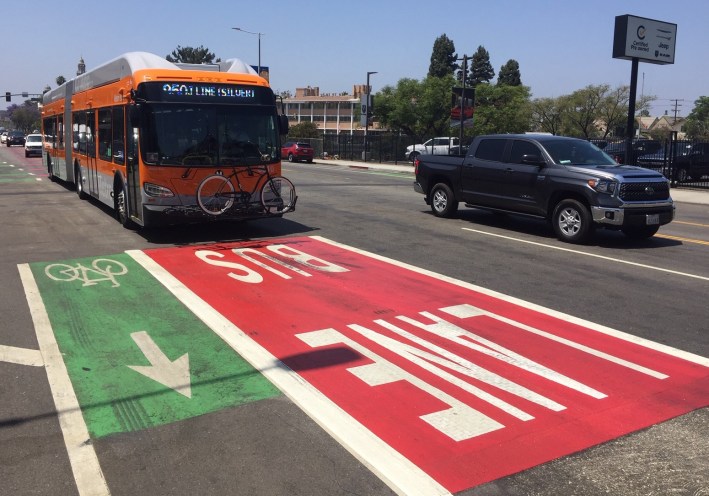Red bus lane markings next to green bike lane markings give MyFigueroa a Christmas color motif
