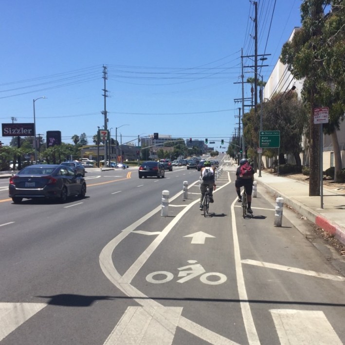 Newly protected bike lanes on Manchester Avenue. All photos by Joe Linton/Streetsblog L.A.