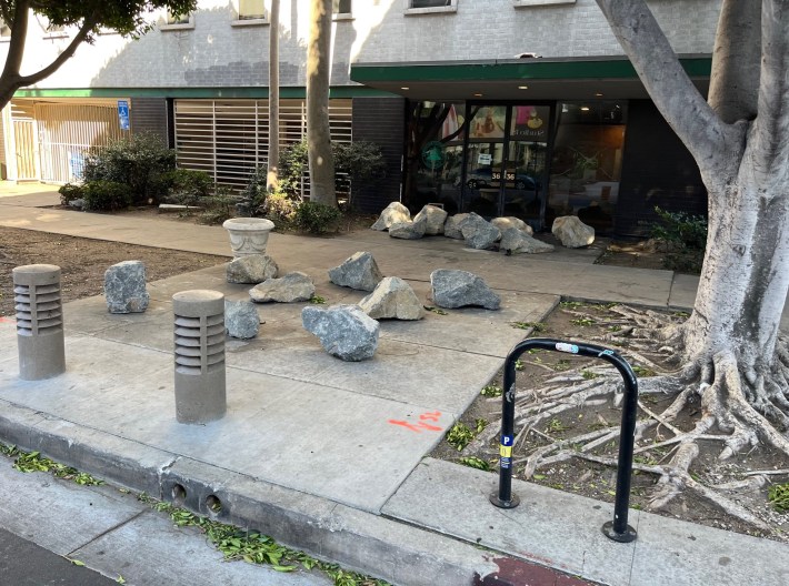 Not sure that the Fire Marshall will like these large rocks blocking the apparently little-use front door of the office building at 519 Shatto Place
