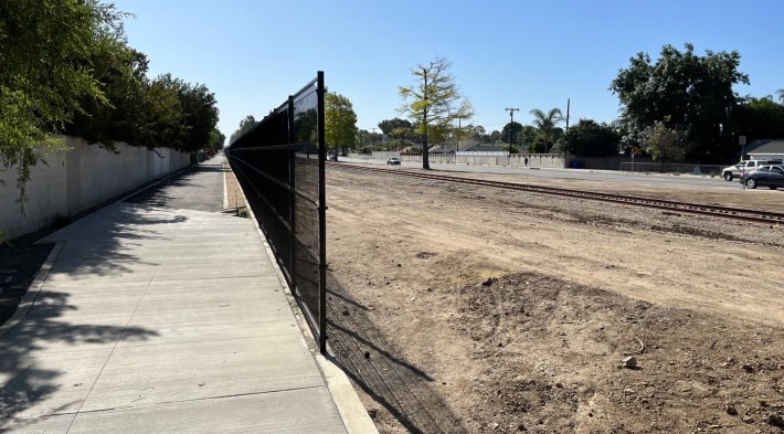 The under construction bike/walk path (left) runs along active railroad tracks (right)
