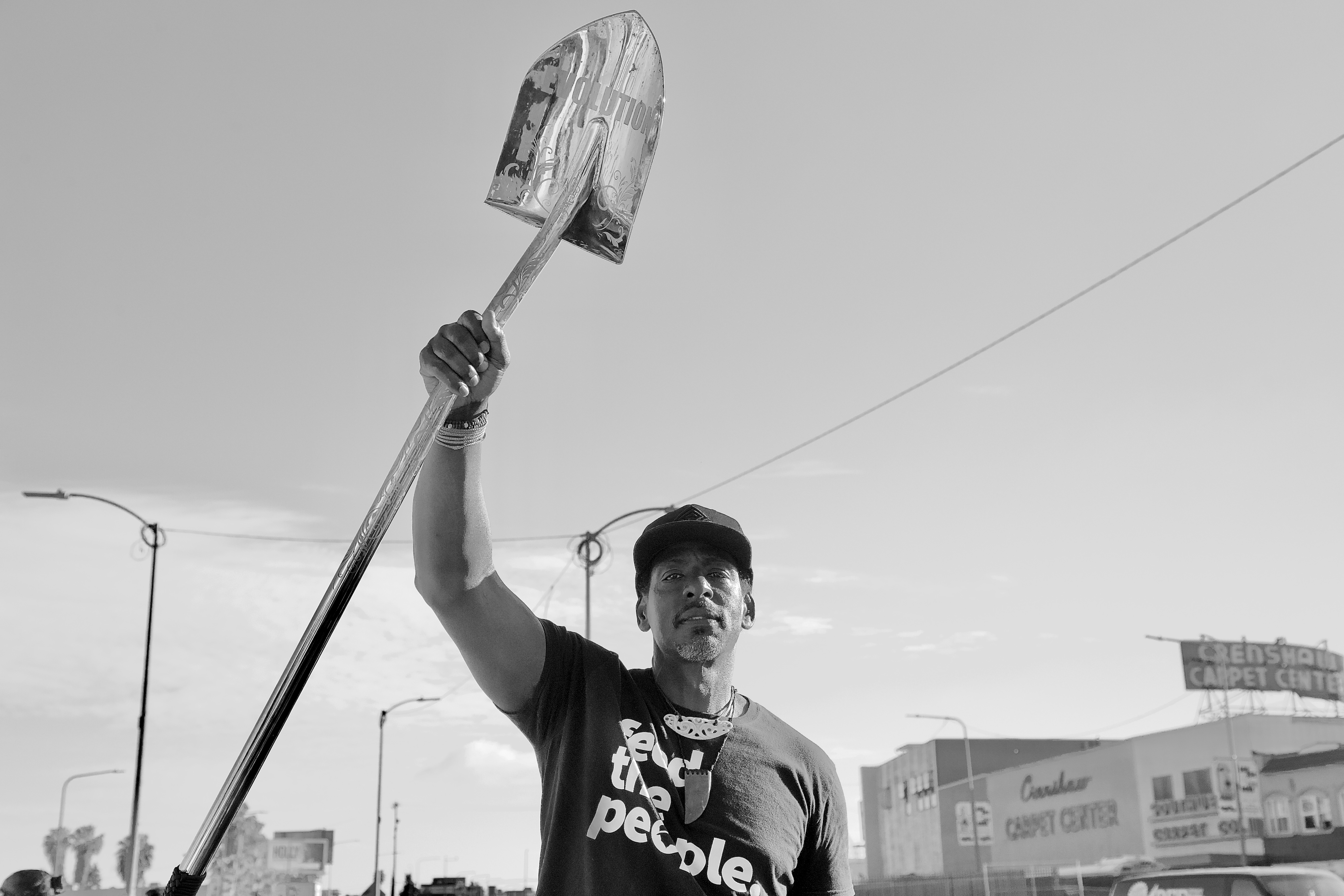The Gangsta Gardener Ron Finley holds up a shovel he designed at the groundbreaking for Destination Crenshaw in 2020. Sahra Sulaiman/Streetsblog L.A.