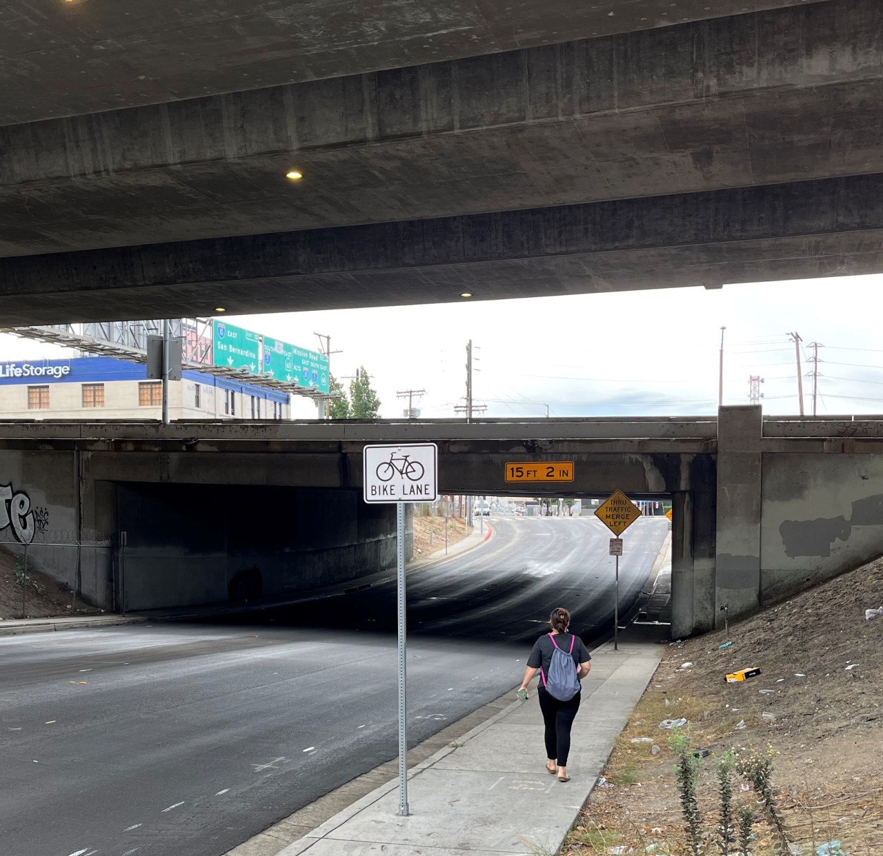 The relatively quiet Ramirez Street crosses under the 101 Freeway. Preliminary bike lane markings and new bike lane sign visible.