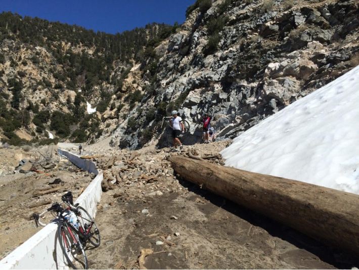 Cyclists traverse part of the closed section of Highway 39 after a storm. Courtesy Peter Rinde.